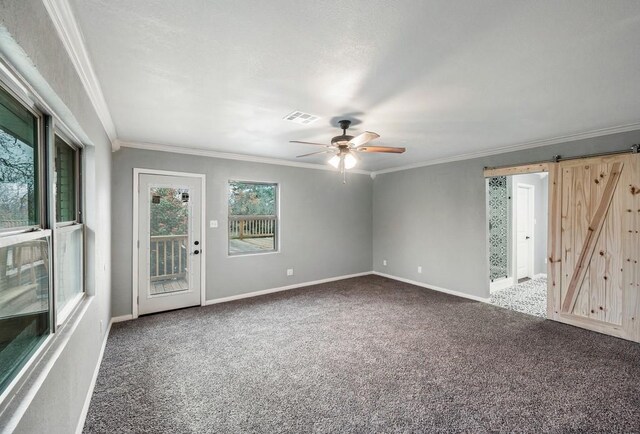 433 Sharron Dr, Woodway, TX 76712 - carpeted spare room featuring a ceiling fan, visible vents, baseboards, crown molding, and a barn door