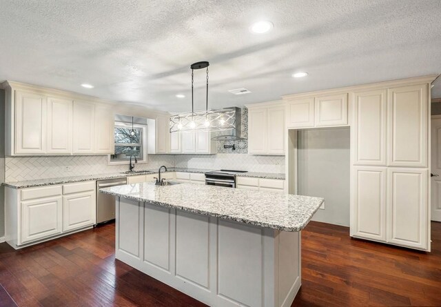 433 Sharron Dr, Woodway, TX 76712 - kitchen featuring an island with sink, a sink, stainless steel appliances, wall chimney exhaust hood, and dark wood-style flooring