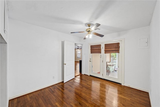 interior space with access to exterior, visible vents, baseboards, a ceiling fan, and wood-type flooring