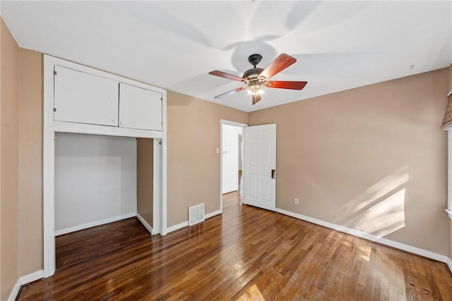 unfurnished bedroom featuring visible vents, baseboards, a closet, a ceiling fan, and wood-type flooring