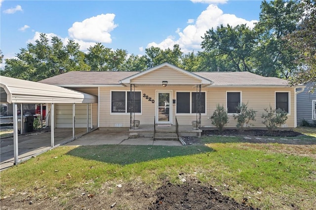 ranch-style home featuring a detached carport and a front yard