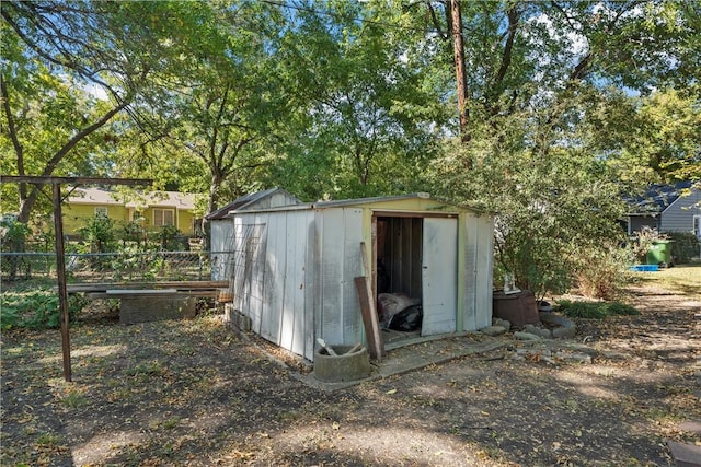 view of shed featuring fence
