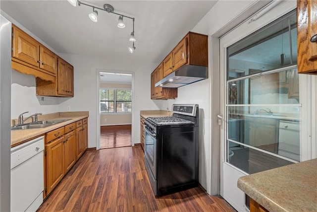 kitchen with a sink, white dishwasher, under cabinet range hood, and stainless steel gas range oven