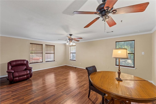 living area with visible vents, ornamental molding, a ceiling fan, wood finished floors, and baseboards