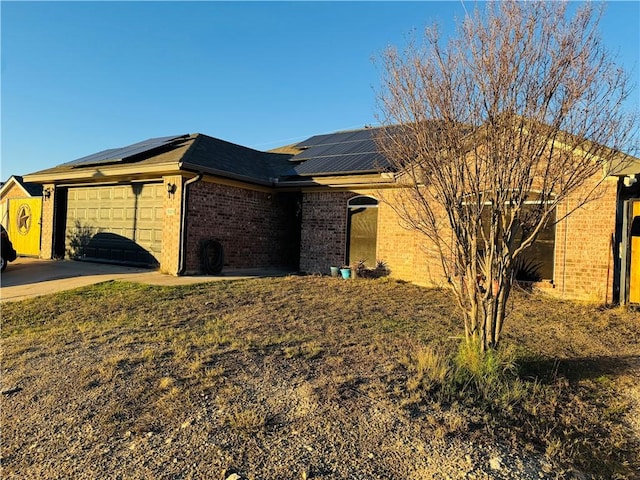 5703 Mandalay Dr, Killeen, TX 76549 - view of home's exterior with brick siding, roof mounted solar panels, driveway, and a garage