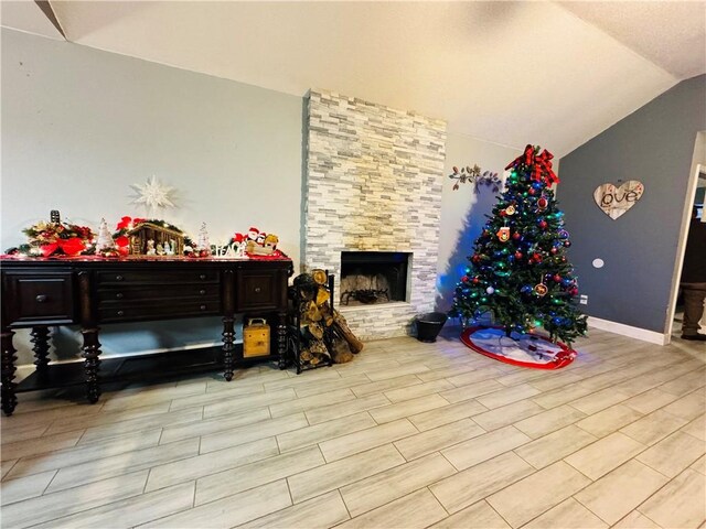 5703 Mandalay Dr, Killeen, TX 76549 - living area with wood finish floors, baseboards, lofted ceiling, and a stone fireplace