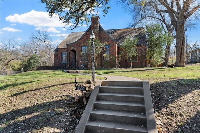 3100 Austin Ave, Waco, TX 76710 - tudor house with a front lawn, brick siding, and a chimney