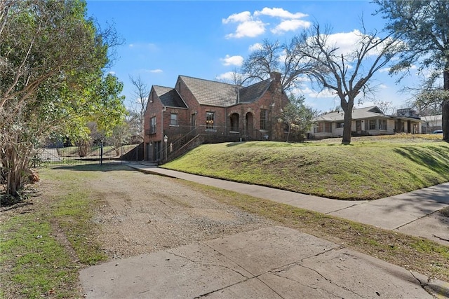 3100 Austin Ave, Waco, TX 76710 - view of front facade featuring a chimney, a front lawn, brick siding, and dirt driveway