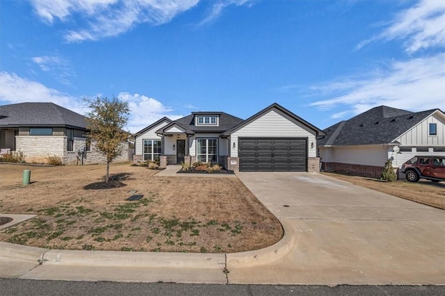 view of front facade with brick siding, driveway, and an attached garage