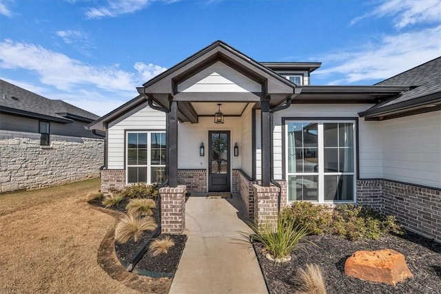 property entrance featuring brick siding