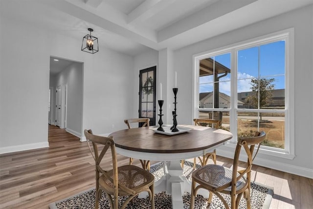 dining space with light wood finished floors and baseboards