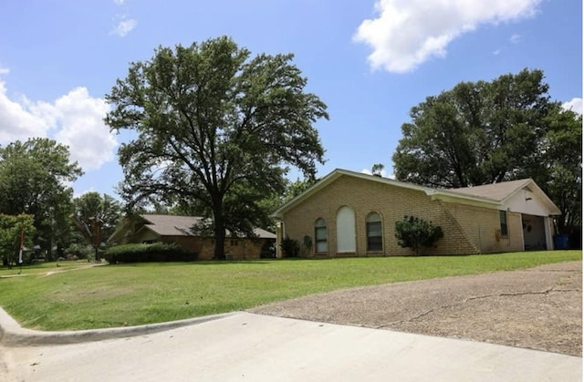 332 Crescent Dr, Hewitt, TX 76643 - view of home's exterior with a lawn and brick siding