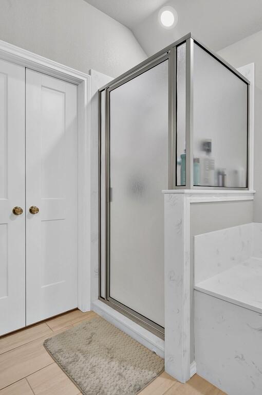 429 Travis Dr, Mcgregor, TX 76657 - bathroom with a stall shower and wood finished floors