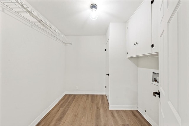 4209 Chestnut Rd, Temple, TX 76502 - washroom featuring washer hookup, cabinet space, baseboards, and light wood finished floors