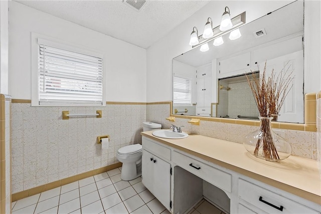 4209 Chestnut Rd, Temple, TX 76502 - bathroom featuring visible vents, toilet, a textured ceiling, a shower stall, and tile patterned flooring