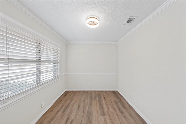4209 Chestnut Rd, Temple, TX 76502 - unfurnished room featuring wood finished floors, baseboards, visible vents, ornamental molding, and a textured ceiling