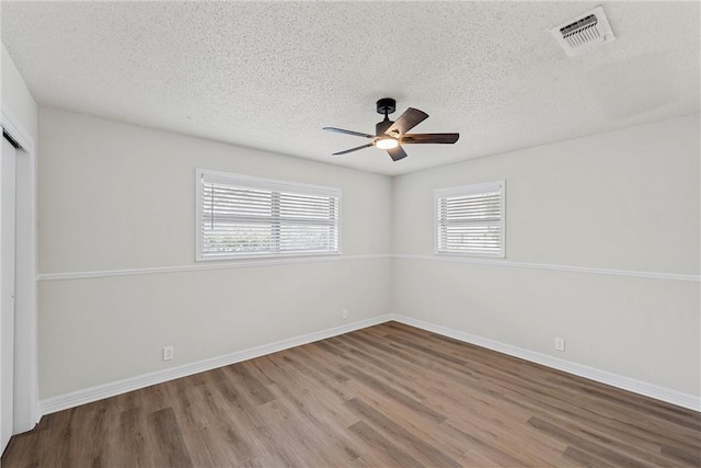 4209 Chestnut Rd, Temple, TX 76502 - spare room with visible vents, a textured ceiling, a ceiling fan, and wood finished floors
