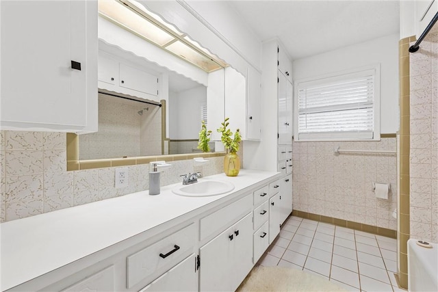 4209 Chestnut Rd, Temple, TX 76502 - full bathroom featuring tile patterned floors, tile walls, wainscoting, a shower, and vanity