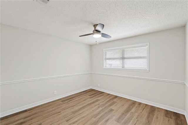 4209 Chestnut Rd, Temple, TX 76502 - spare room with baseboards, a textured ceiling, wood finished floors, and a ceiling fan