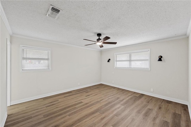 4209 Chestnut Rd, Temple, TX 76502 - unfurnished room with visible vents, ornamental molding, a ceiling fan, and wood finished floors