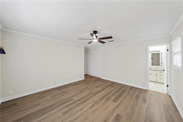 4209 Chestnut Rd, Temple, TX 76502 - interior space with light wood-type flooring, a ceiling fan, a textured ceiling, crown molding, and baseboards
