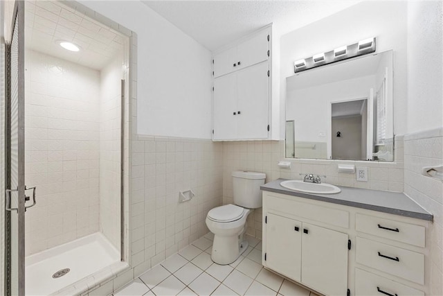 4209 Chestnut Rd, Temple, TX 76502 - full bathroom with a shower stall, toilet, tile walls, and tile patterned floors