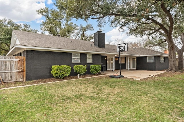 4209 Chestnut Rd, Temple, TX 76502 - back of property with brick siding, fence, a lawn, a chimney, and a patio area