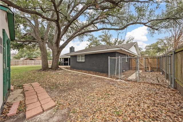 4209 Chestnut Rd, Temple, TX 76502 - exterior space featuring a fenced backyard, brick siding, and a chimney