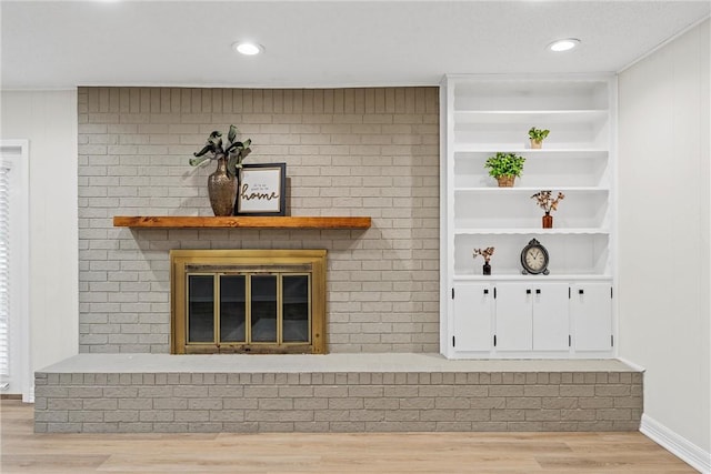 4209 Chestnut Rd, Temple, TX 76502 - room details featuring built in shelves, wood finished floors, recessed lighting, a fireplace, and baseboards