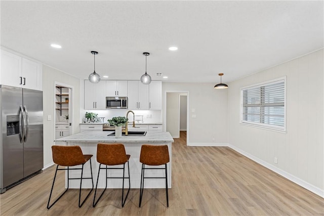 4209 Chestnut Rd, Temple, TX 76502 - kitchen featuring a sink, light wood-style flooring, white cabinetry, and stainless steel appliances