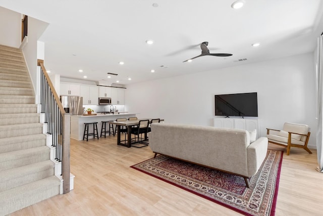 851 Cavitt Ct, Prosper, TX 75078 - living room featuring stairway, light wood-style flooring, recessed lighting, and a ceiling fan