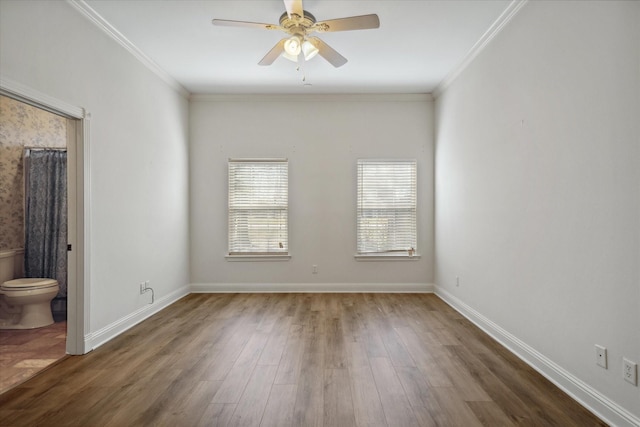 unfurnished room with crown molding, wood finished floors, baseboards, and ceiling fan