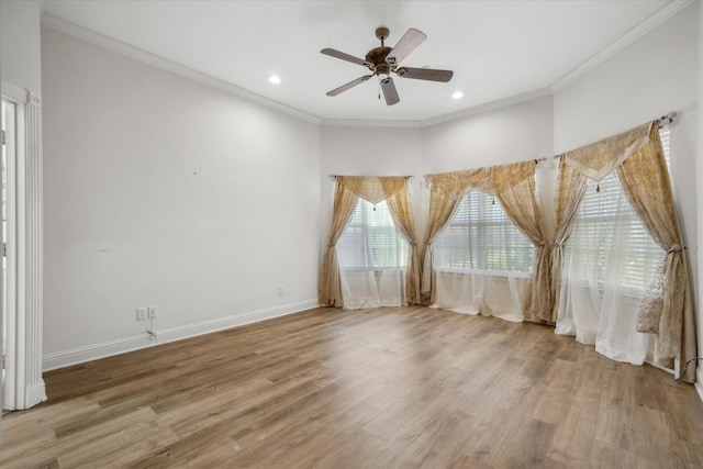 unfurnished room with baseboards, a ceiling fan, wood finished floors, and crown molding