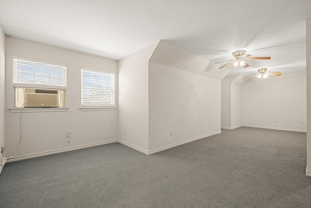 carpeted spare room with cooling unit, baseboards, a ceiling fan, and vaulted ceiling