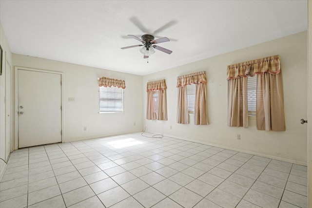 unfurnished room featuring light tile patterned floors, baseboards, and ceiling fan