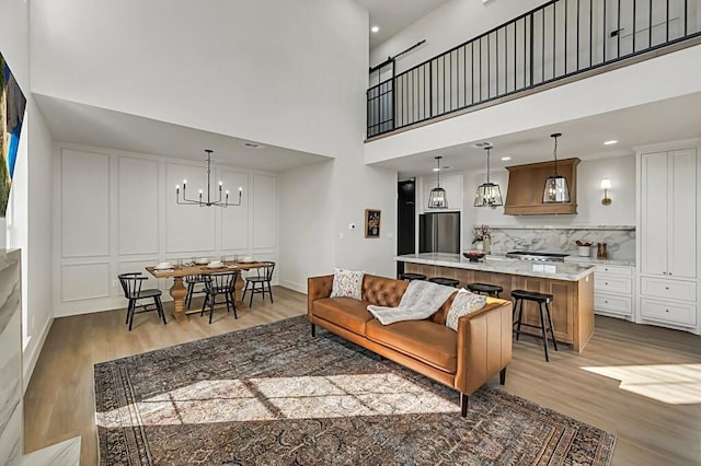707 S 9th St, Waco, TX 76706 - living area with recessed lighting, a high ceiling, an inviting chandelier, and light wood finished floors