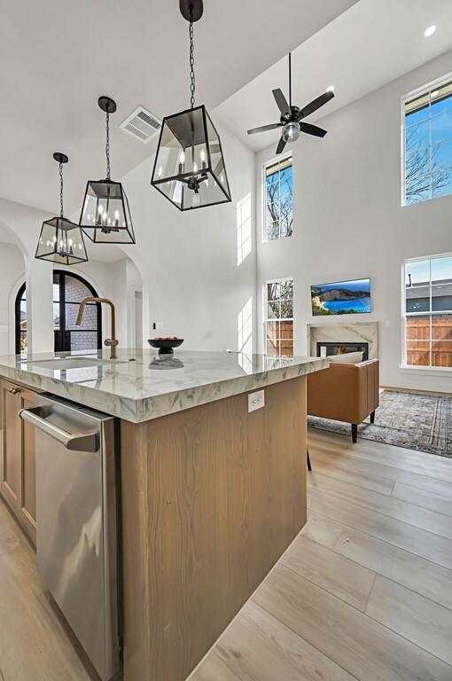 707 S 9th St, Waco, TX 76706 - kitchen featuring a sink, arched walkways, dishwasher, and open floor plan
