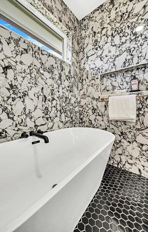 707 S 9th St, Waco, TX 76706 - bathroom with tile patterned floors, a freestanding tub, and wallpapered walls