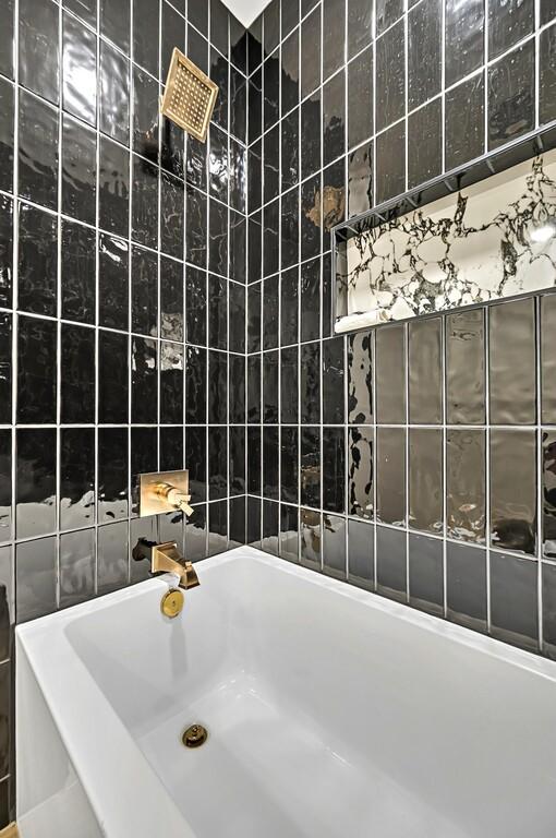 707 S 9th St, Waco, TX 76706 - full bathroom featuring tile walls and a tub to relax in