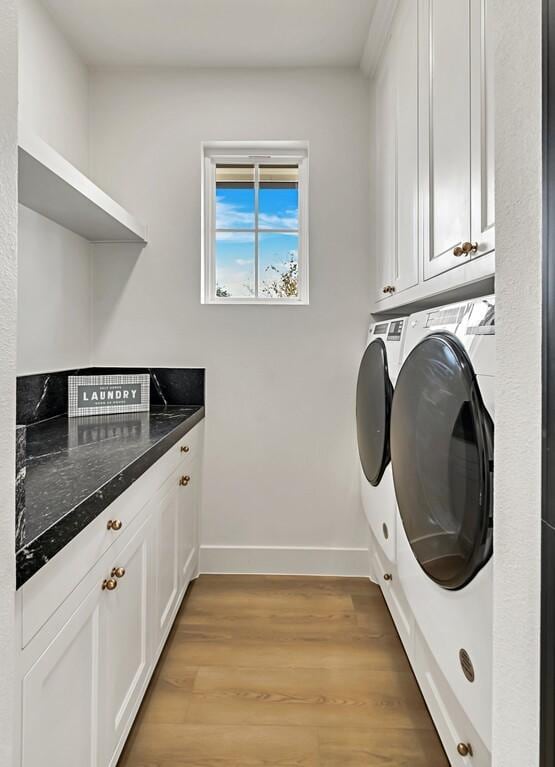 707 S 9th St, Waco, TX 76706 - laundry area with washing machine and clothes dryer, cabinet space, light wood-type flooring, and baseboards