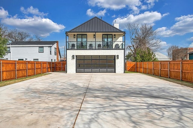 707 S 9th St, Waco, TX 76706 - modern home with brick siding, fence, concrete driveway, a balcony, and a garage