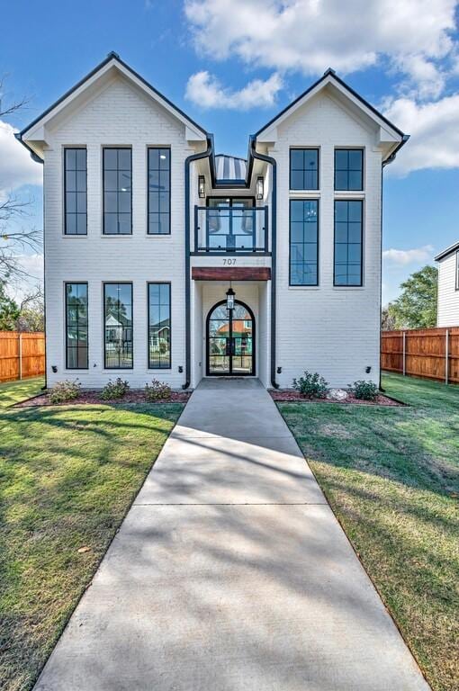 707 S 9th St, Waco, TX 76706 - view of front of house with a front lawn, a balcony, and fence