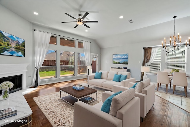 8664 Glenburne Dr, Fort Worth, TX 76131 - living area featuring visible vents, a fireplace, ceiling fan with notable chandelier, recessed lighting, and vaulted ceiling