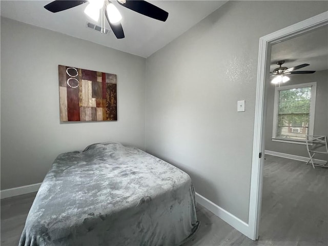 bedroom featuring ceiling fan, baseboards, and visible vents