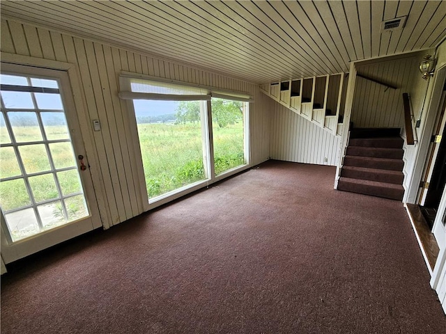 338 Lcr 866, Donie, TX 75838 - unfurnished living room featuring stairway, dark colored carpet, and wood walls