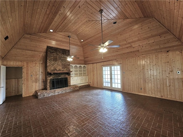 338 Lcr 866, Donie, TX 75838 - unfurnished living room with high vaulted ceiling, wooden walls, brick patterned floors, ceiling fan, and a brick fireplace