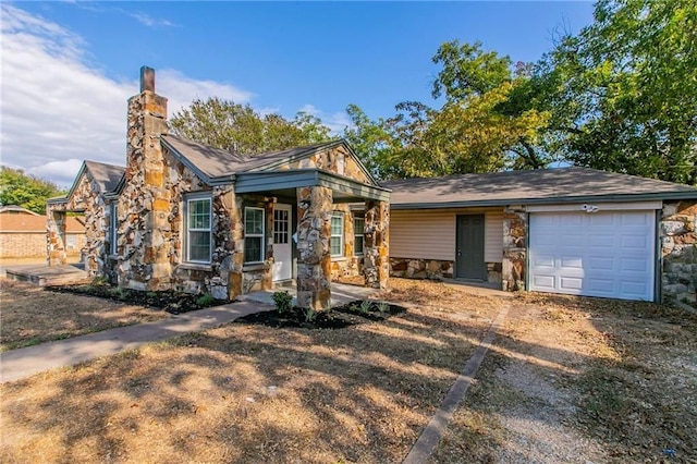 2400 Ethel Ave, Waco, TX 76707 - view of front of property with a porch, a chimney, a garage, stone siding, and driveway