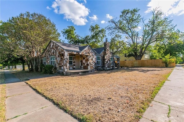 2400 Ethel Ave, Waco, TX 76707 - view of front of house with fence, stone siding, and a chimney