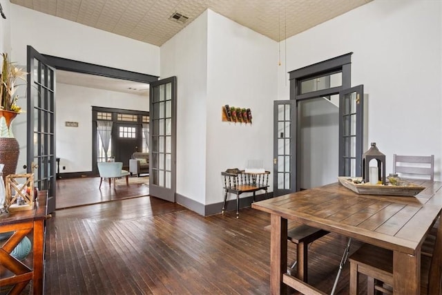 506 E Frederick St, Riesel, TX 76682 - dining space with baseboards, french doors, wood-type flooring, and visible vents