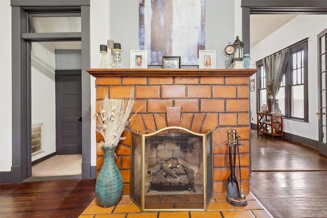 506 E Frederick St, Riesel, TX 76682 - room details with wood finished floors, a fireplace, and baseboards
